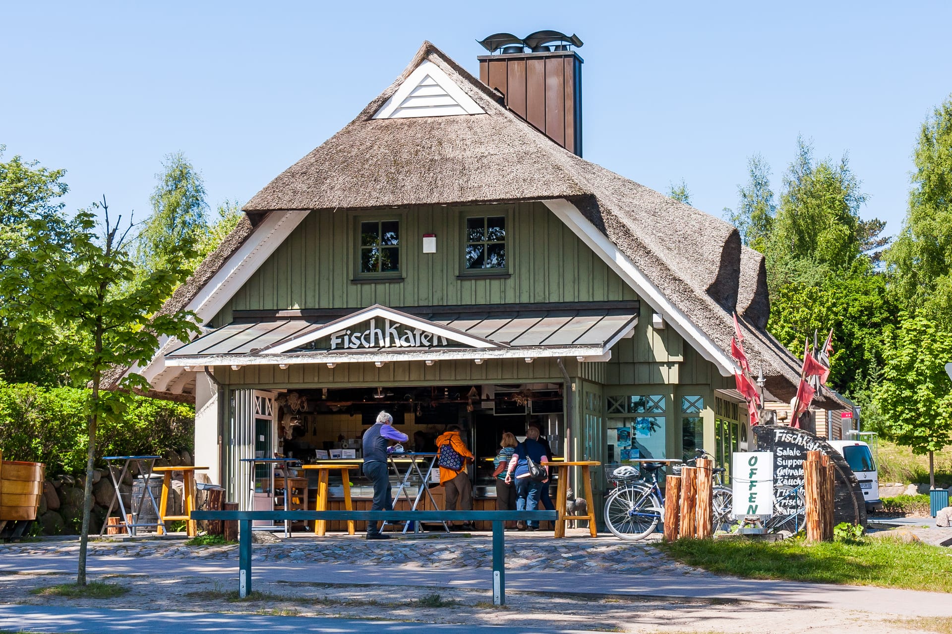 Menschen stehen vor einem Restaurant und bestellen.