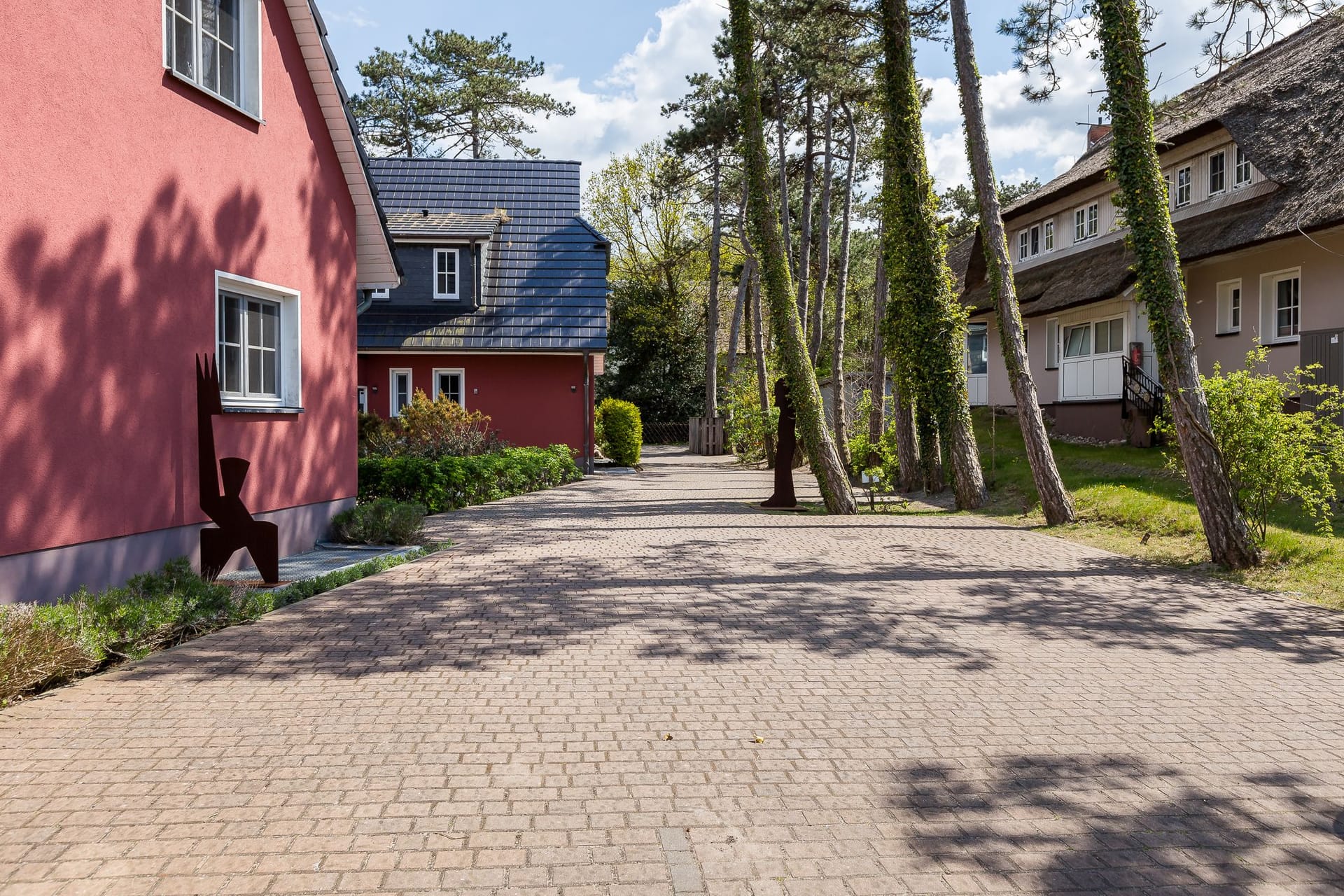 Außenansicht einer Wohnanlage mit gepflastertem Weg.