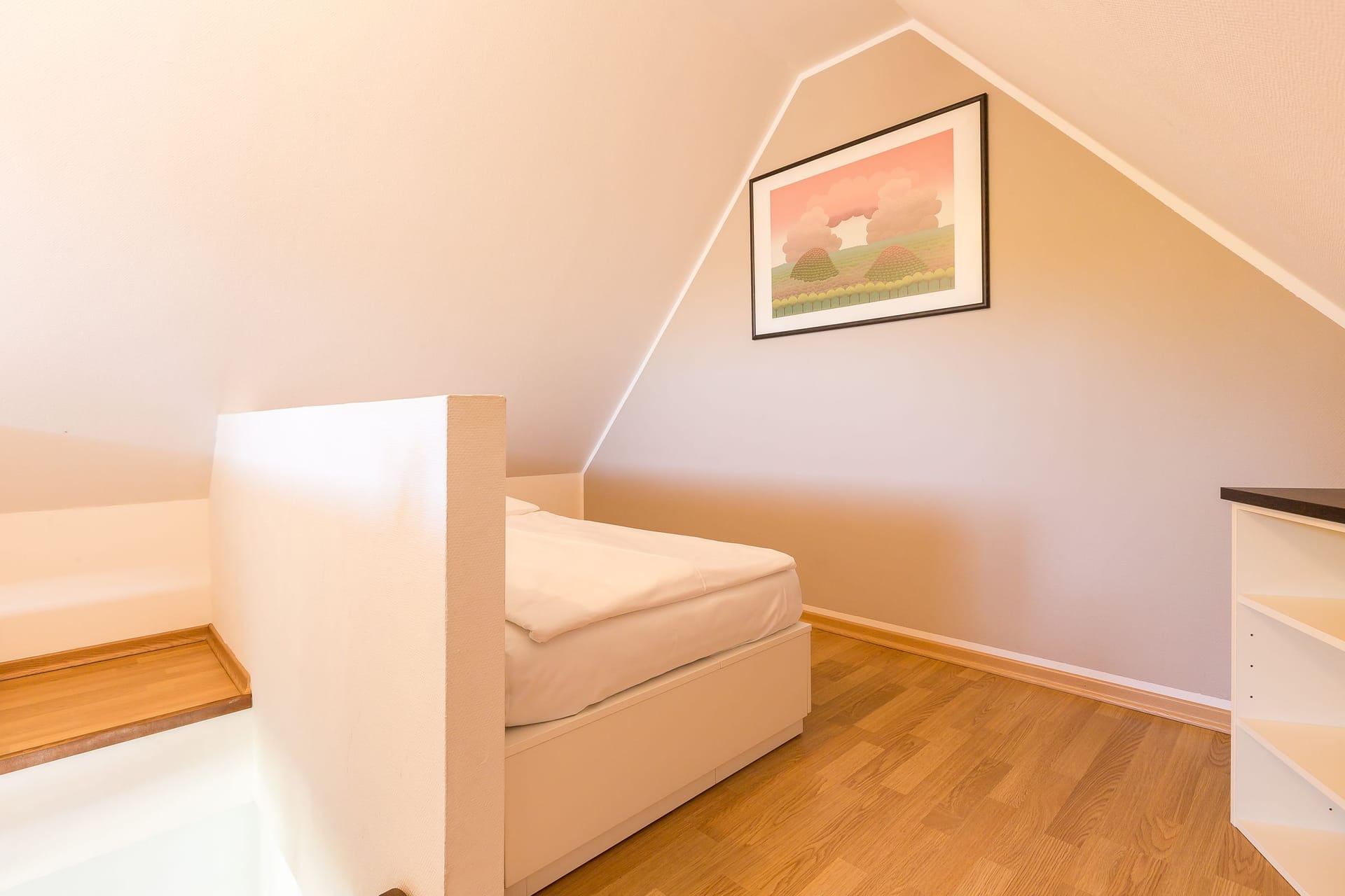 Helles Schlafzimmer mit Einzelbett und Regal