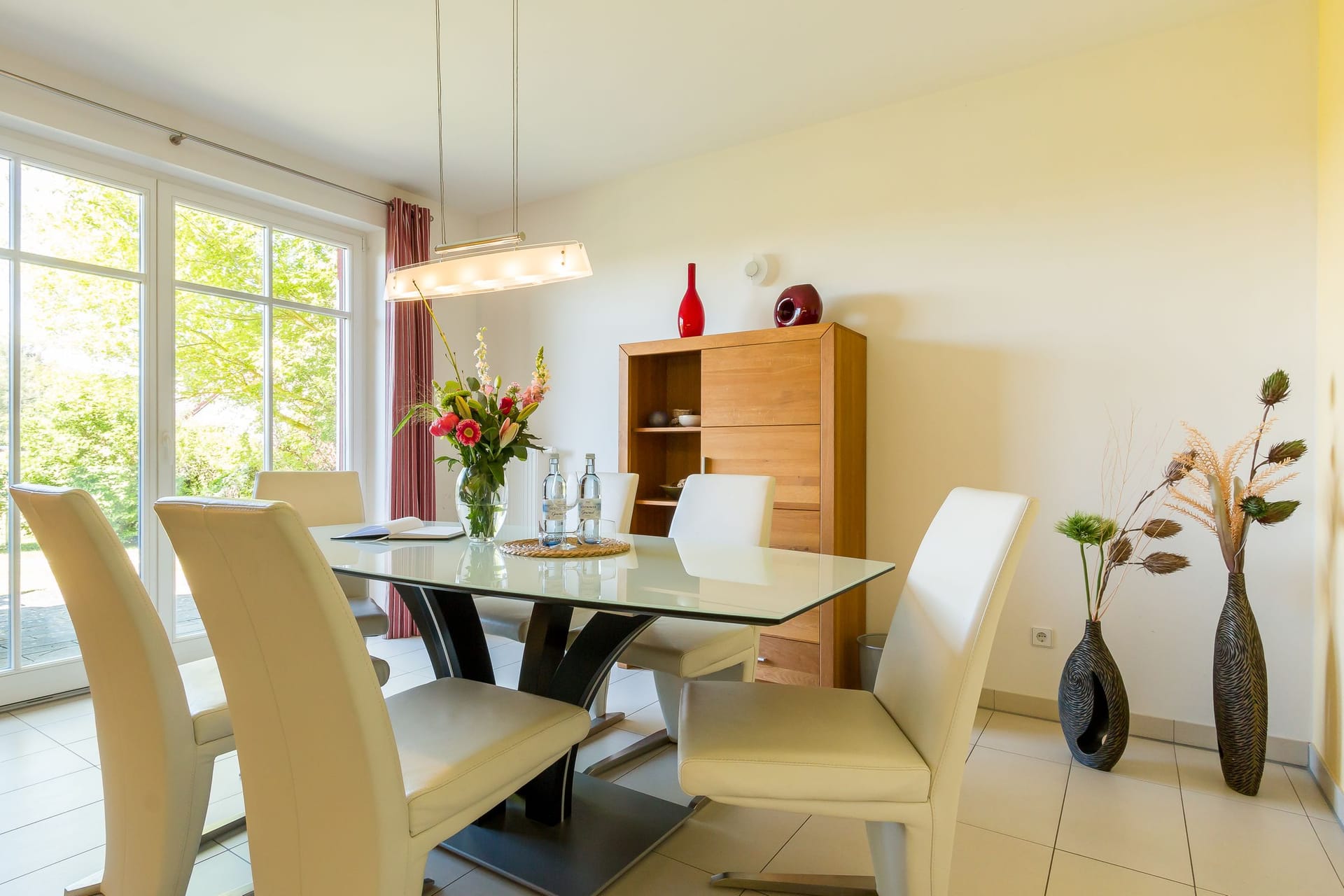 Essbereich mit gläsernem Tisch und weißen Stühlen