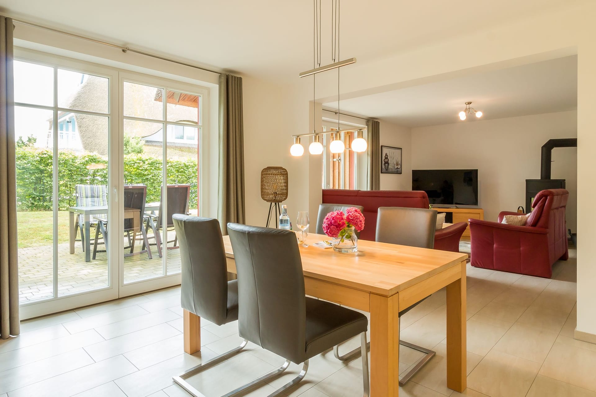 Wohnbereich mit Tisch, Stühlen und Fernseher.