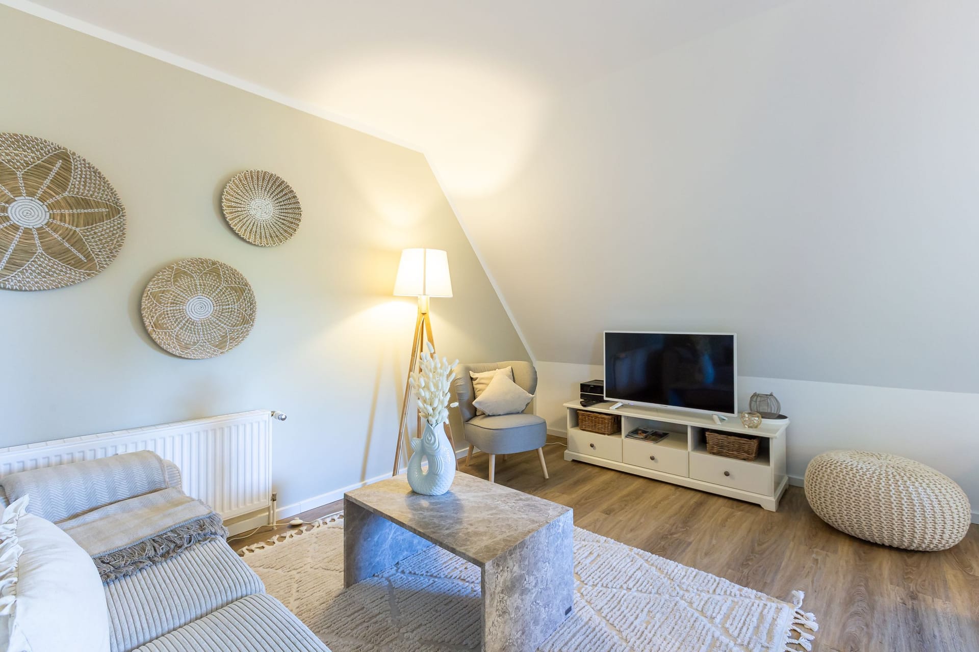 Helles Wohnzimmer mit Sofa und Fernseher