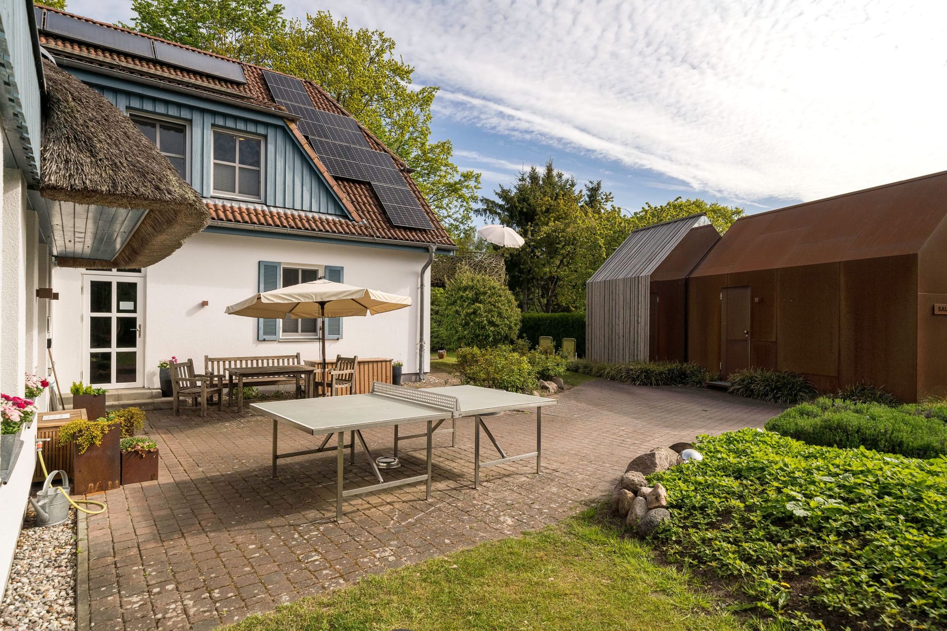 Außenansicht eines Hauses mit Terrasse und Garten