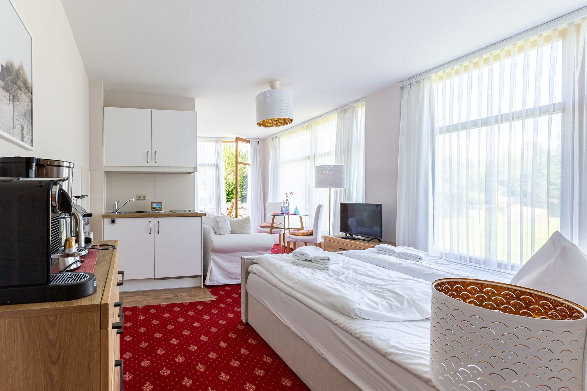 Helles Schlafzimmer mit Sofa und Küchenzeile