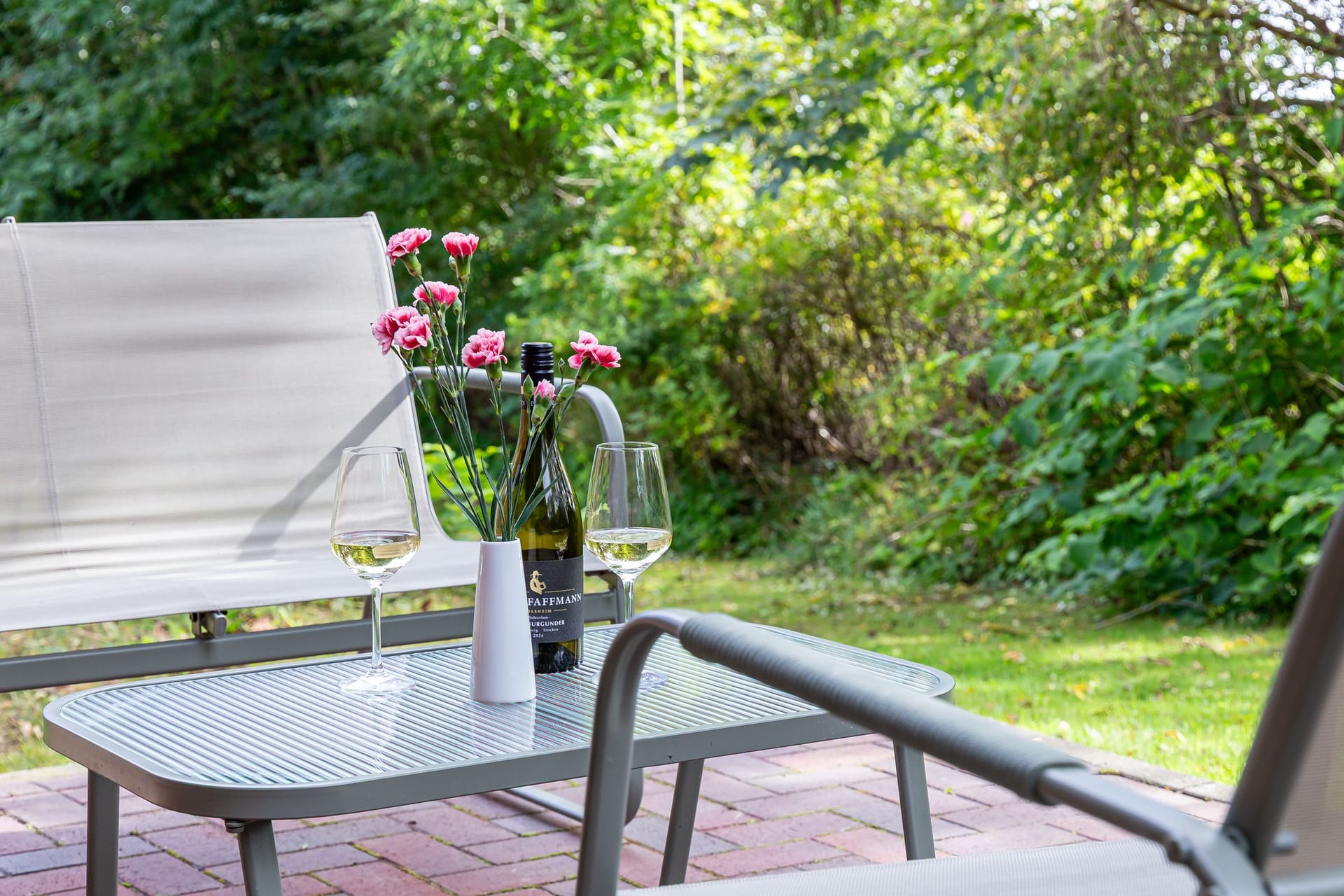 Terrasse mit Tisch, Stühlen und Blumen