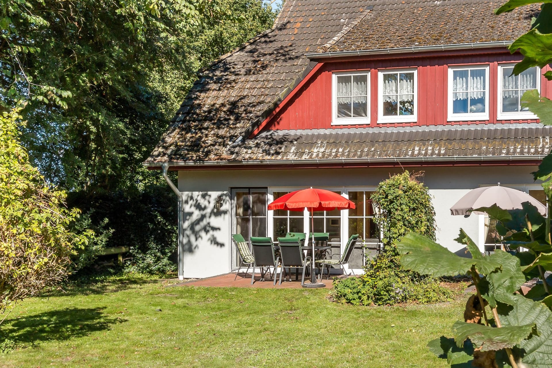 Terrasse mit Tisch und Sonnenschirmen