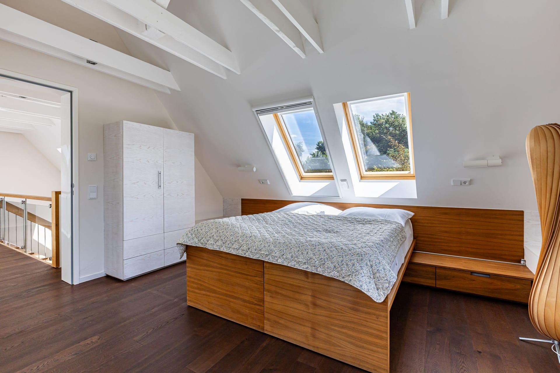 Schlafzimmer mit Holzfußboden und Fensterkuppeln