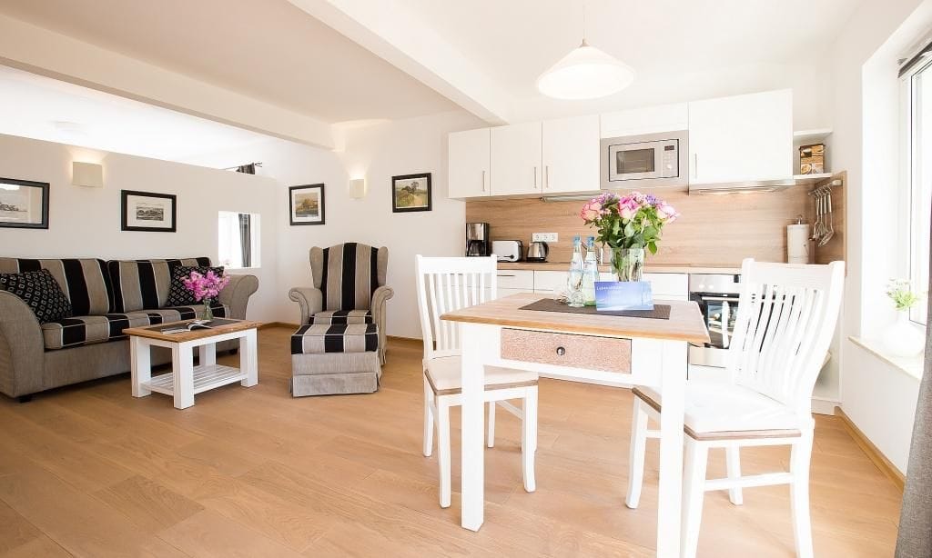 Helles Wohnzimmer mit Esstisch und Sofas