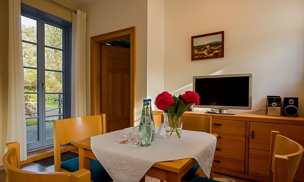 Gemütliches Wohnzimmer mit Fernseher und Tisch