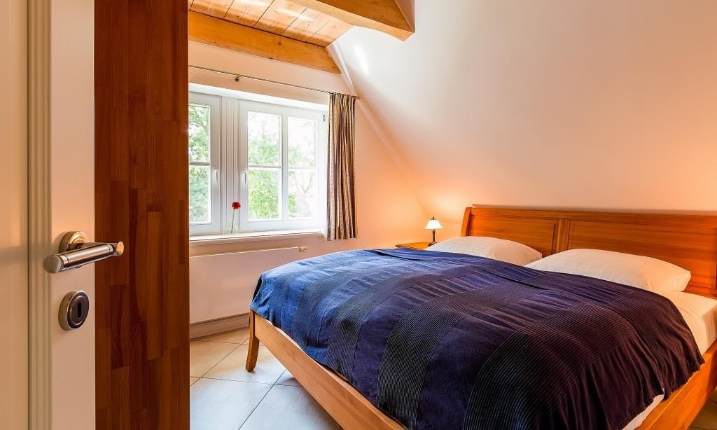 Schlafzimmer mit Doppelbett und Fenster