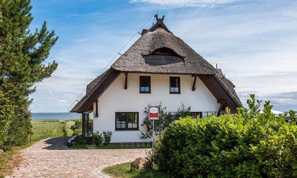 Außenansicht eines charmanten Ferienhauses mit Reetdach
