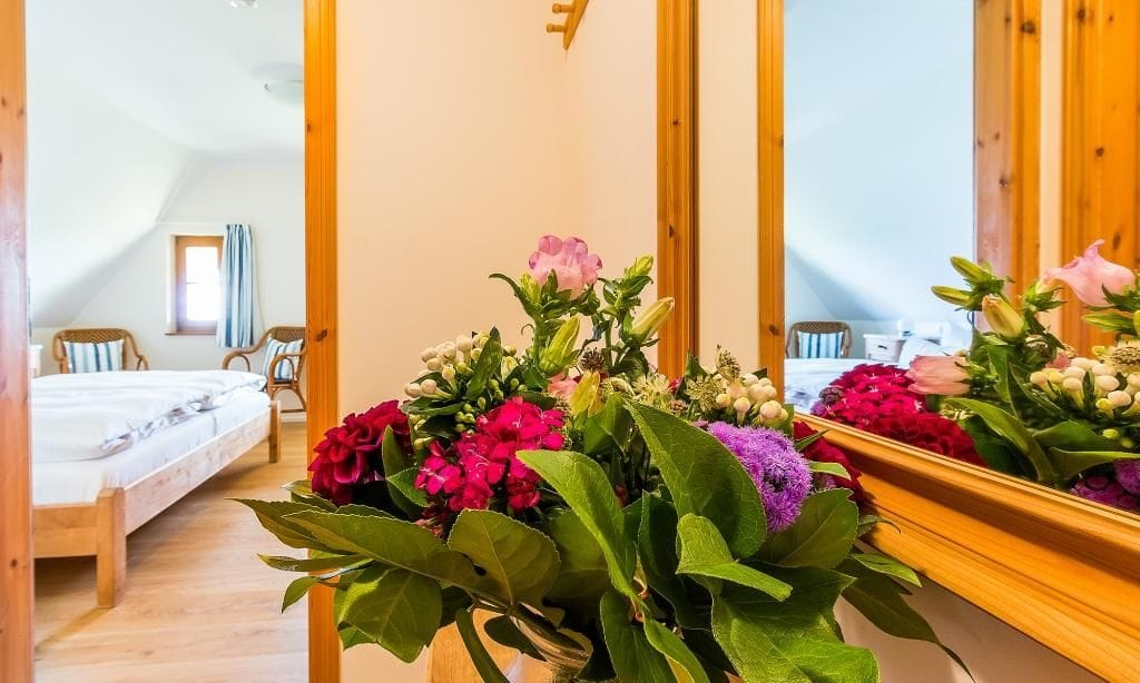 Schlafzimmer mit Blumen und Spiegel