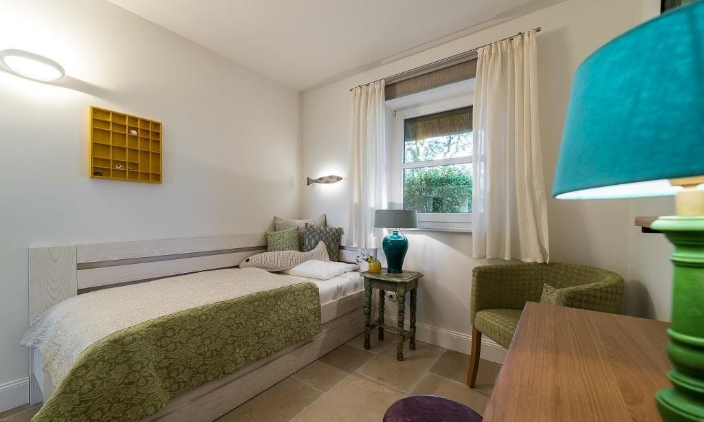 Gemütliches Schlafzimmer mit Einzelbett und Tisch