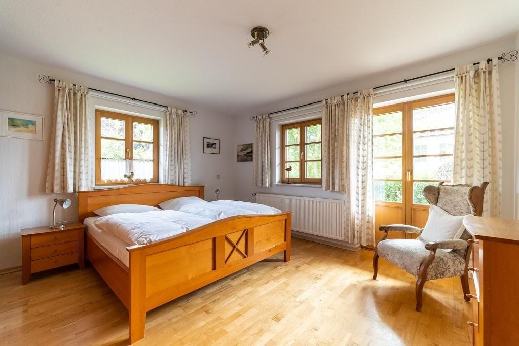 Helles Schlafzimmer mit Doppelbett und Fenster