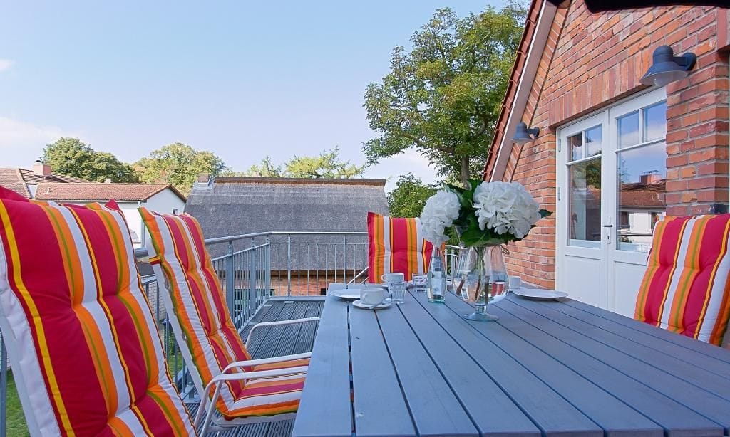 Terrasse mit bunten Stühlen und Tisch