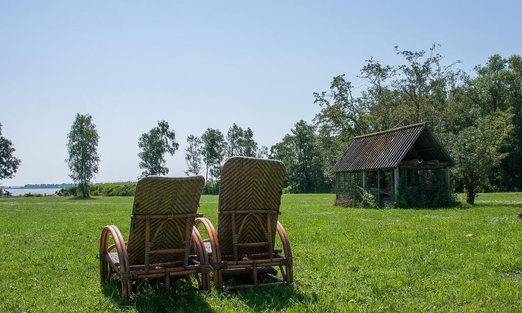 Liegestühle auf der Wiese vor einem Gartenhaus