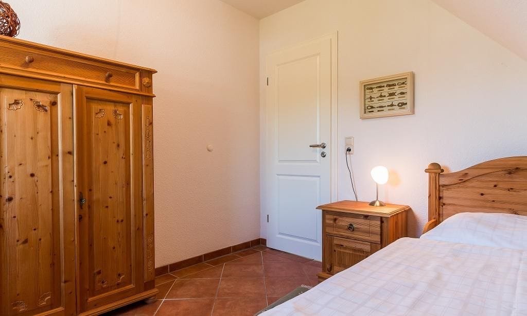 Schlafzimmer mit Holzschrank und Nachttisch