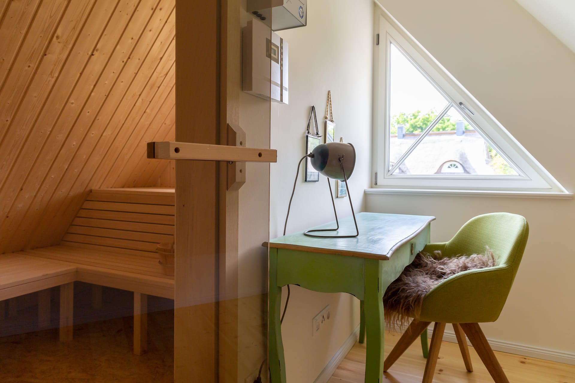 Grüner Schreibtisch mit Stuhl neben einer Sauna